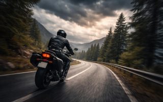 motard-route-sinueuse-montagne-nuages